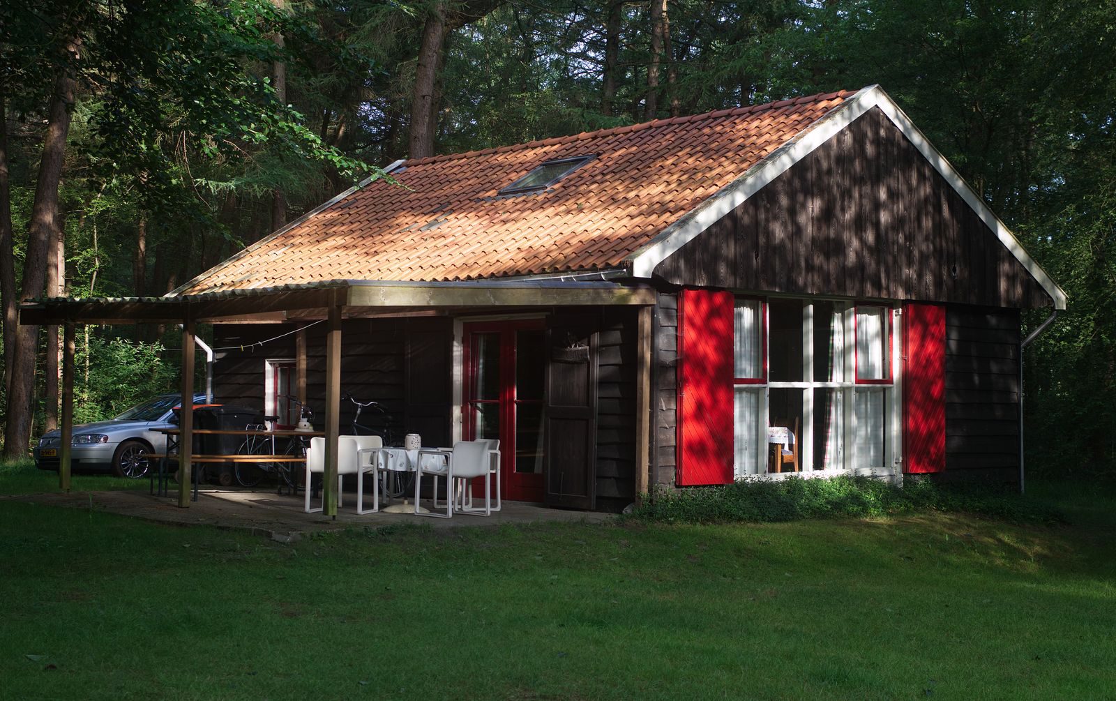 A cozy wooden cabin in a lush forest clearing, perfect for rural retreats.